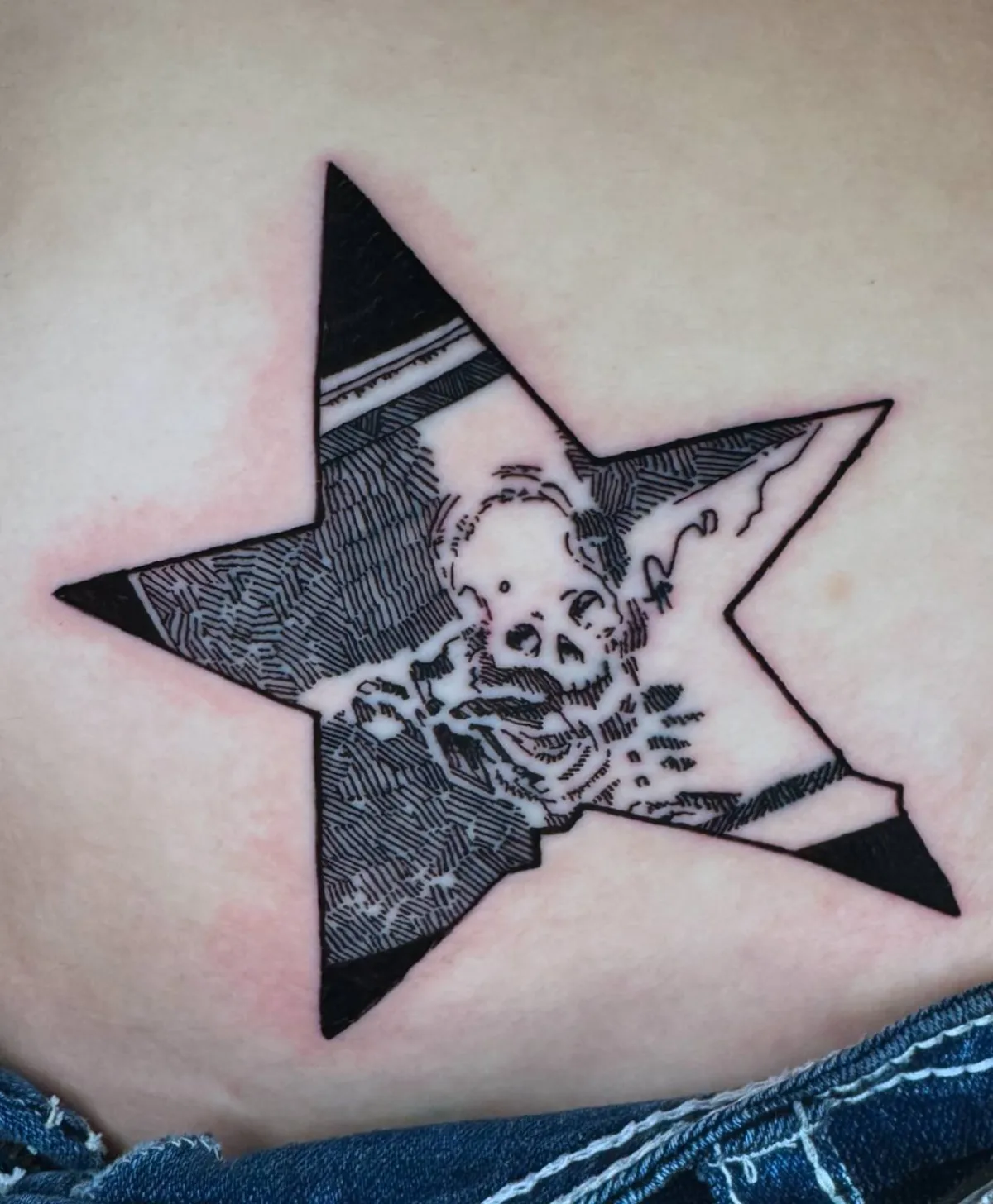 Black and grey skull star tattoo by Corvus Caine