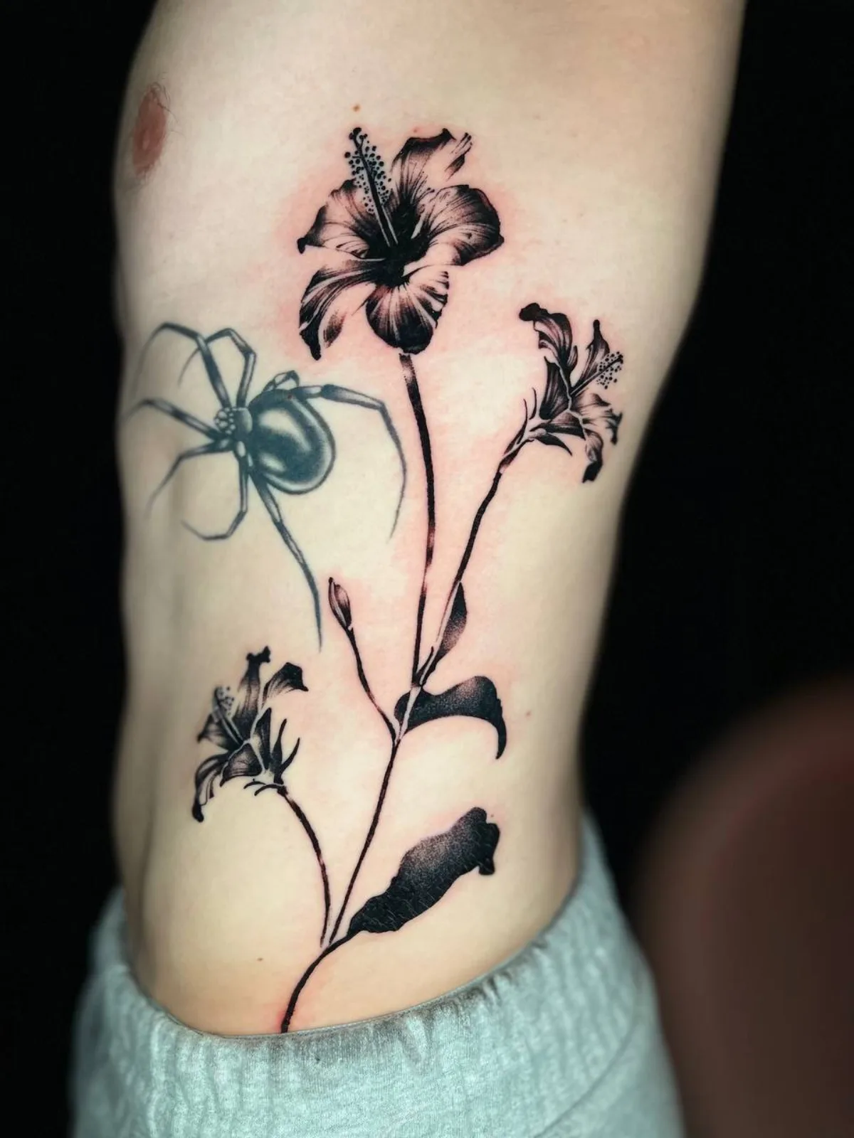 Black and grey spider and floral tattoo by Corvus Caine